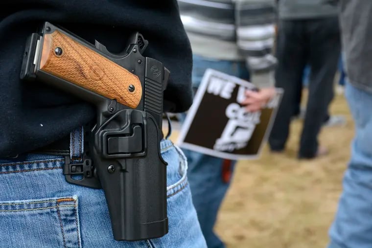 FILE - In this April 5, 2014, file photo, a man open carries a 1911 handgun while at a gun rights rally at the Connecticut state capitol in Hartford. (Mike Orazzi/The Bristol Press via AP, File)