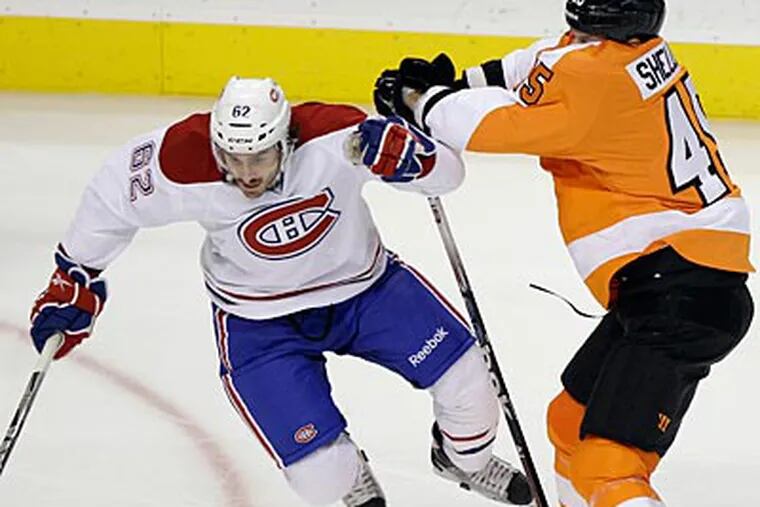 Jody Shelley collides with Frederic St. Denis during the Flyers' win. (Matt Slocum/AP)