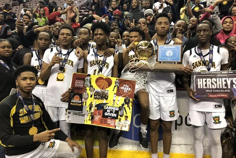 Sankofa's boys' basketball team celebrates its state championship at the Giant Center.