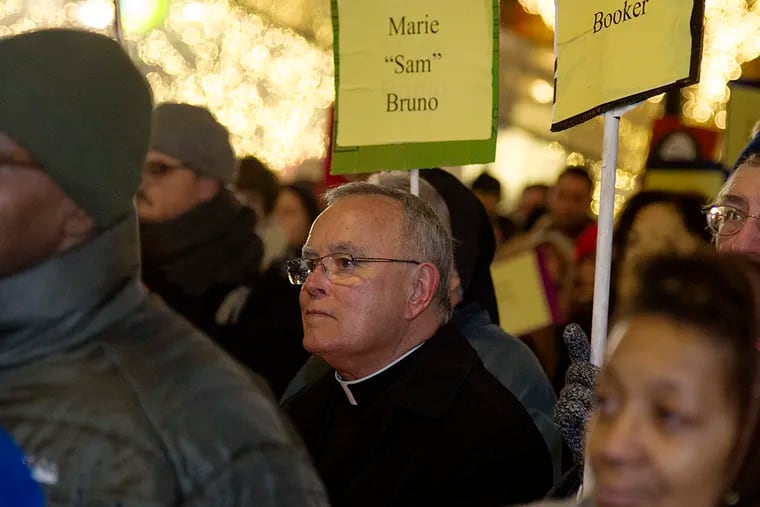 Archbishop Charles Chaput and others gather in Dilworth Park to participate for the "Homeless Memorial Day" program Dec. 18, 2014. ( CLEM MURRAY / Staff Photographer )