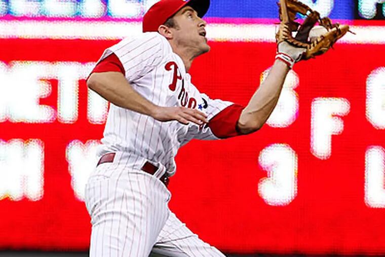 Chase Utley reaches back to catch a fly ball in the second inning. (Ron Cortes/Staff Photographer)