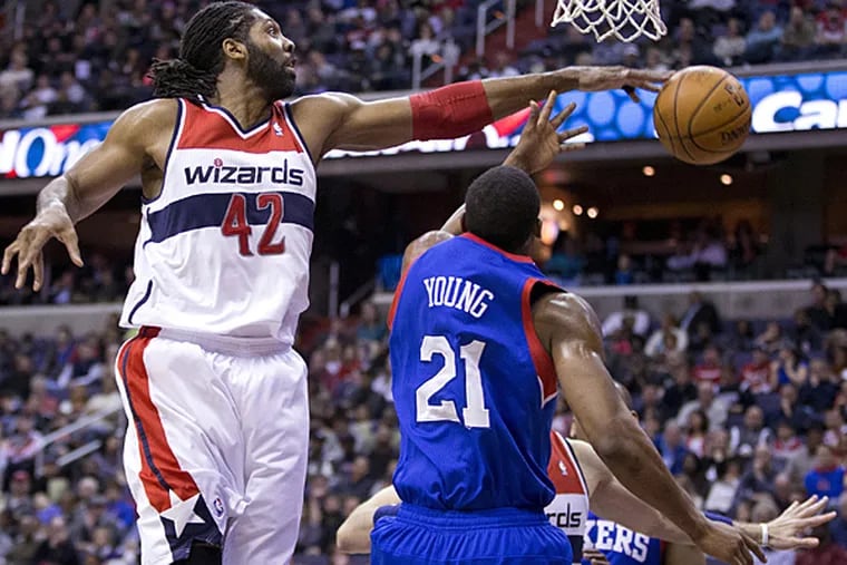 Wizards power forward Nene, blocks a shot by 76ers forward Thaddeus Young during the first half on Monday, January 20. (Evan Vucci/AP)