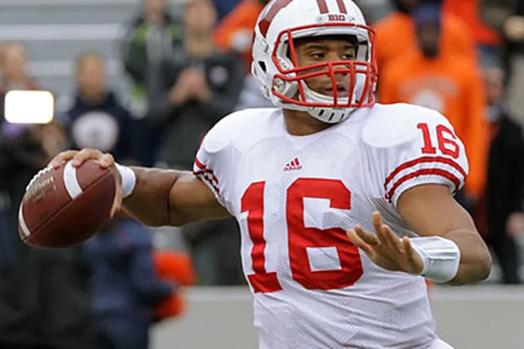 Russell Wilson used his last year of eligibility at Wisconsin after graduating from North Carolina State (Seth Perlman/AP Photo)