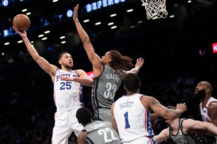 Sixers point guard Ben Simmons (25) goes to the basket against Brooklyn Nets forward Nicolas Claxton (33) during the first half.