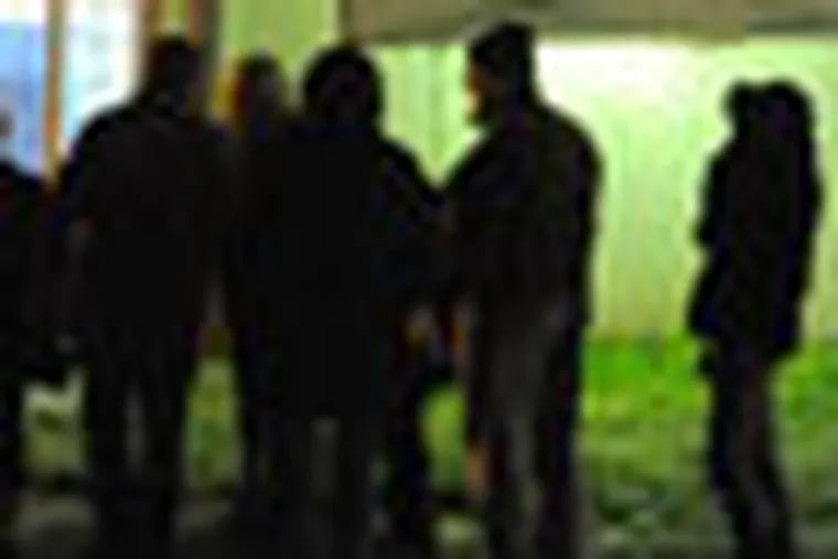 The line of voters at District 6 polling place snakes out the door of the Central Bucks Senior Center in Doylestown at 8:18 pm on election day 2012 as people continue to wait to cast their vote.  The polls closed at 8 pm, but those in line at that time are allowed to wait and cast their ballots. ( CLEM MURRAY / Staff Photographer )