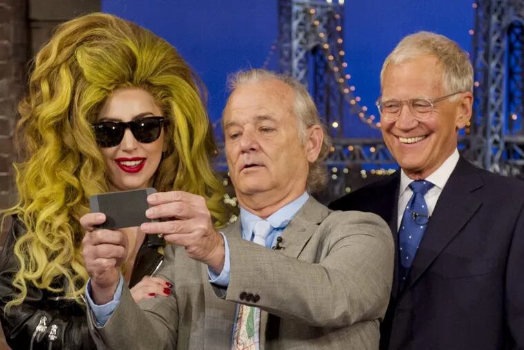 Bill Murray , a Letterman favorite, takes a picture with Lady Gaga and the host during an April 2014 appearance. (JEFFREY R. STAAB / CBS)