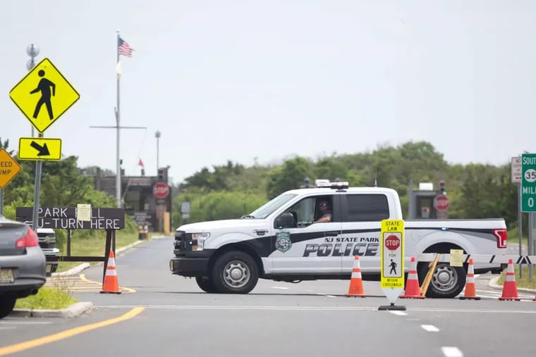 Police cars block the entrance to Island Beach State Park in Ocean County. Officers turned away cars, bicyclists, and joggers.