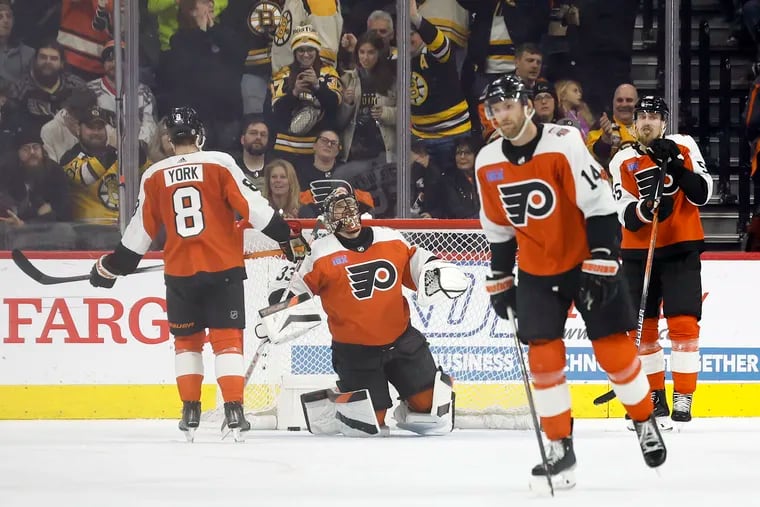 Flyers goaltender Samuel Ersson reacts with his teammates after Boston Bruins right wing David Pastrnak scored his second goal in the first period on Saturday.
