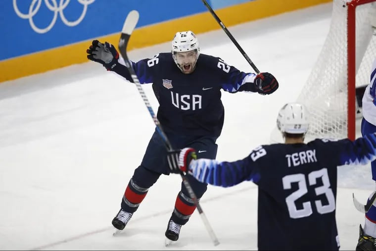 Mark Arcobello celebrates with Troy Terry after scoring a goal during the second period of Team USA’s qualification round win over Slovakia.
