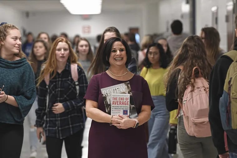 Amy T. Andersen, American Sign Language teacher, smiles for a photograph during change period in the halls of Ocean City High School in Cape May County, N.J. Tuesday, Feb. 6, 2018. Andersen, New Jersey's Teacher of the Year is among four finalists for the national competition later this year. This is only the second time that a New Jersey teacher has been a finalist for the national award.