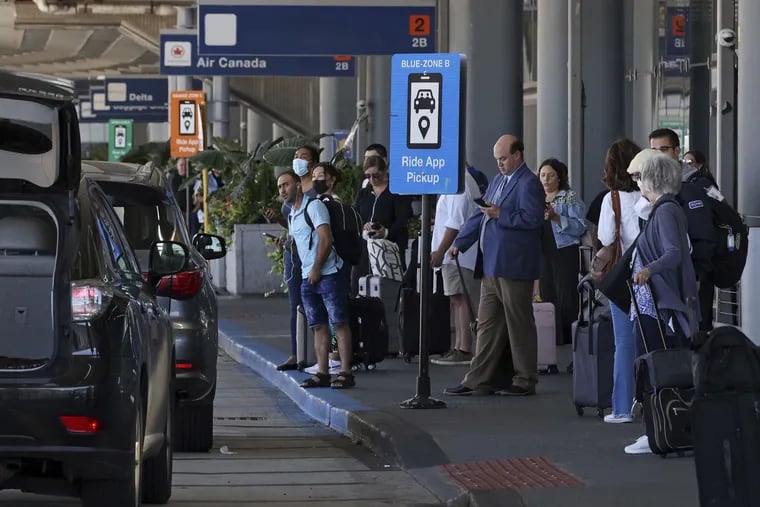 Air passengers wait for ride-share pickups from Terminal 2 at O'Hare International Airport.