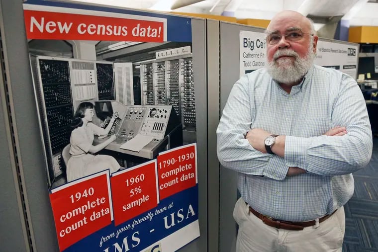 Steven Ruggles, director of the Institute for Social Research and Data Innovation at the University of Minnesota, poses next to a Census Bureau poster.