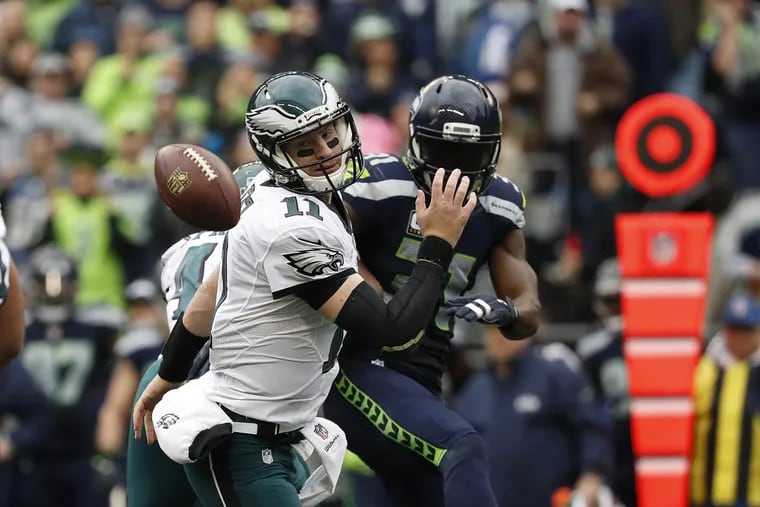 Eagles’ Carson Wentz, left, has a pass blocked by the Seahawks’ Kam Chancellor, right, during the second quarter as the Eagles play the Seahawks in Seattle, WA on November 20, 2016.