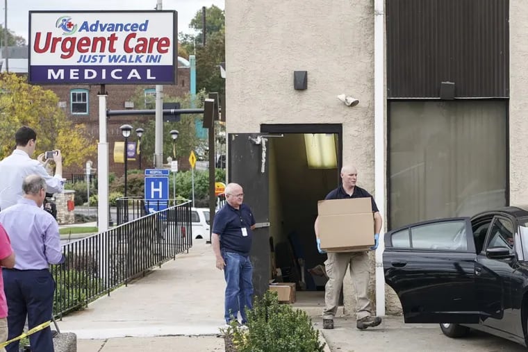 Federal investigators remove boxes of evidence from the Advanced Ugent Care facility in Willow Grove Pa., Monday Oct. 23, 2017.