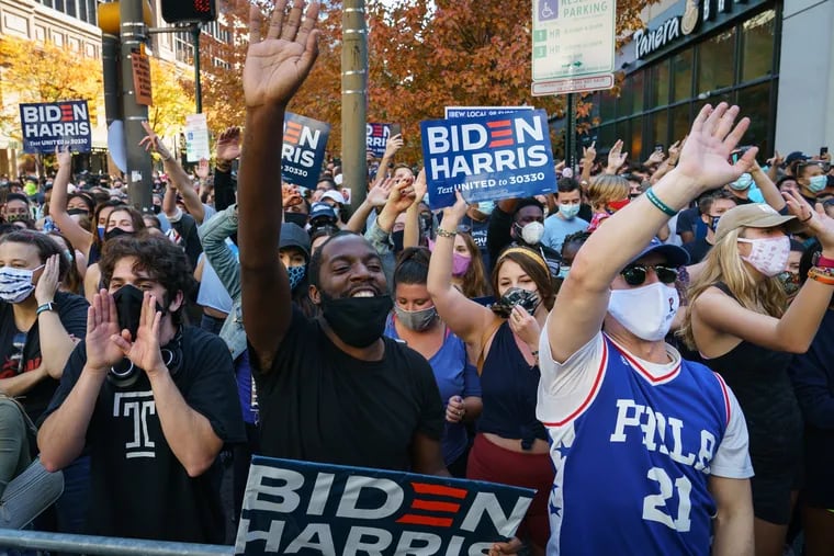 Supporters of Joe Biden celebrate Saturday outside of the Pennsylvania Convention Center in Philadelphia after he became President-elect of the United States.