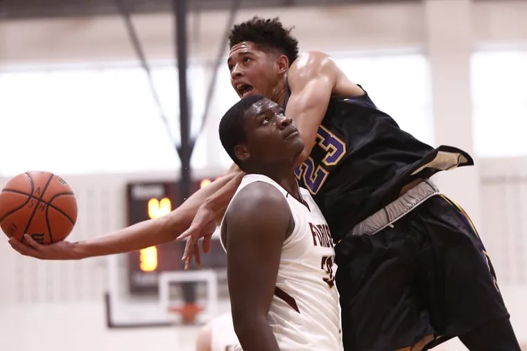 Roman Catholic's Seth Lundy drives to the basket against Haverford School's Asim Richards.