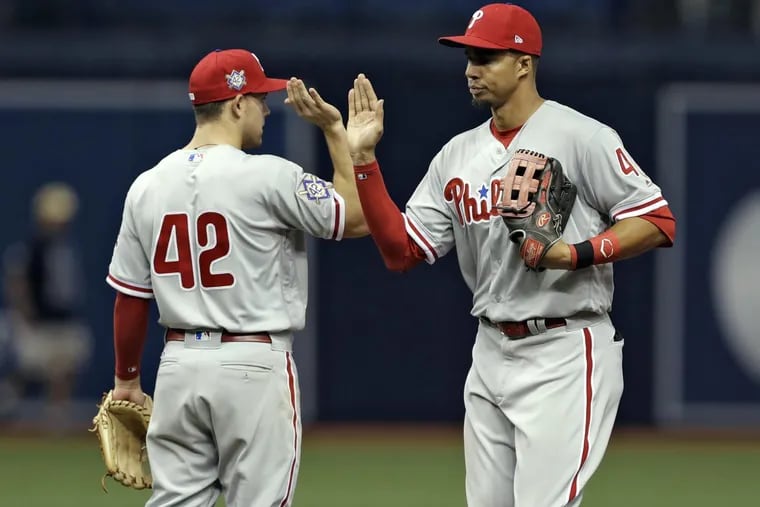Phillies outfielder Aaron Altherr (right) high-fives rookie Scott Kingery during the Phillies’ win against the Tampa Bay Rays on Sunday.