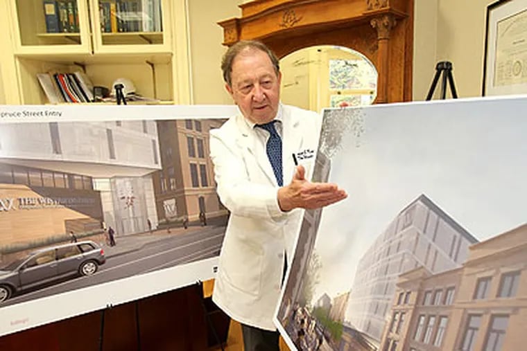 Wistar Institute President and CEO, Dr. Russel Kaufman, looks over two artist's renderings of the expanded facility. (Charles Fox / Staff Photographer)