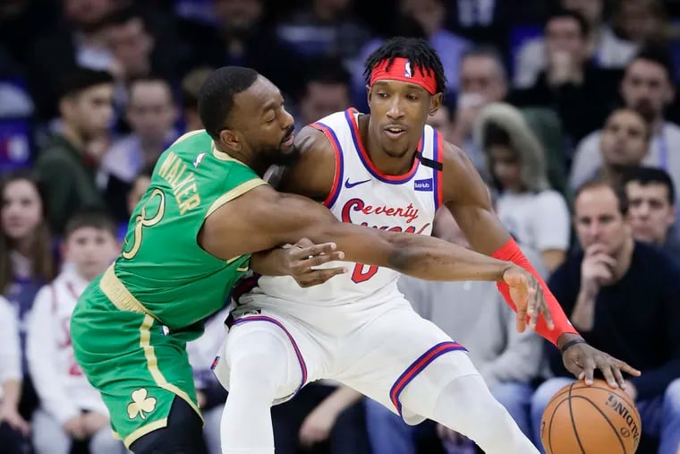 Sixers guard Josh Richardson dribbles the basketball against Boston Celtics guard Kemba Walker during the first-quarter on Thursday, January 9, 2020 in Philadelphia.