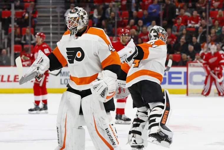 Flyers goaltender Alex Lyon (left) replaces the struggling Petr Mrazek during the second period of Tuesday’s game in Detroit.