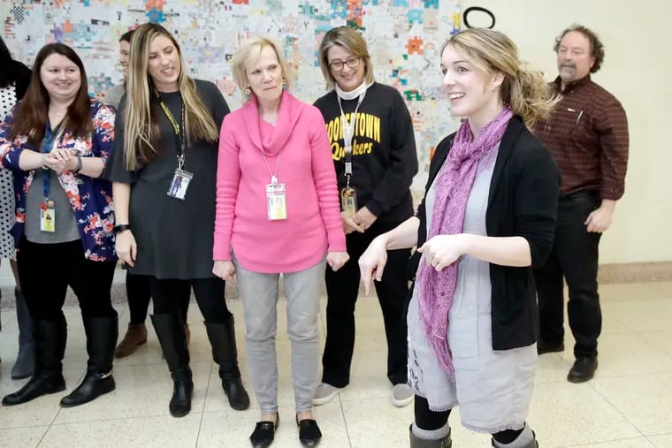 William Allen Middle School teacher Julia Mooney (2nd from right) talks about what she will do with her dress now that her 100 days, one outfit campaign has come to an end at the school in Moorestown,  N.J.