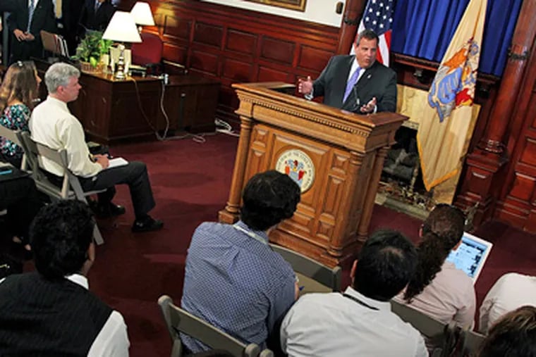 Gov. Christie tells reporters in Trenton that he will allow the state's medical marijuana law to be implemented despite his concerns over whether state regulators might be prosecuted by federal authorities. (Mel Evans / Associated Press)