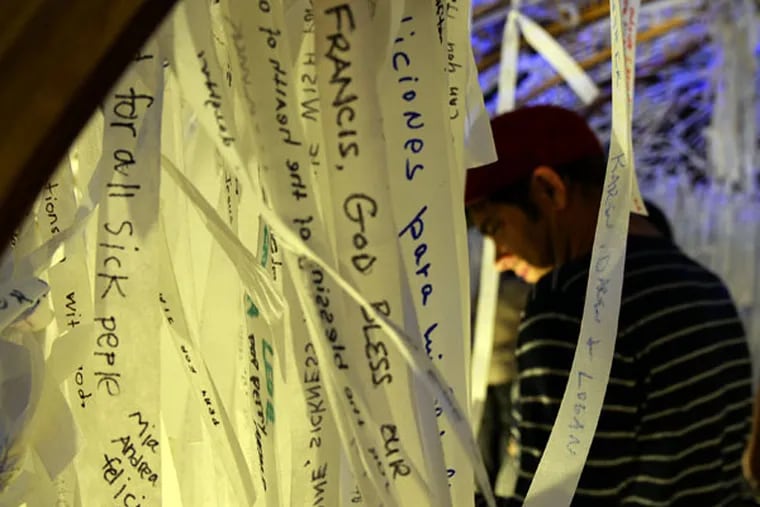 Knotted Grotto visitors write a prayer request on a strip of cloth, then choose and pray for a stranger’s. (TOM GRALISH/STAFF PHOTOGRAPHER)