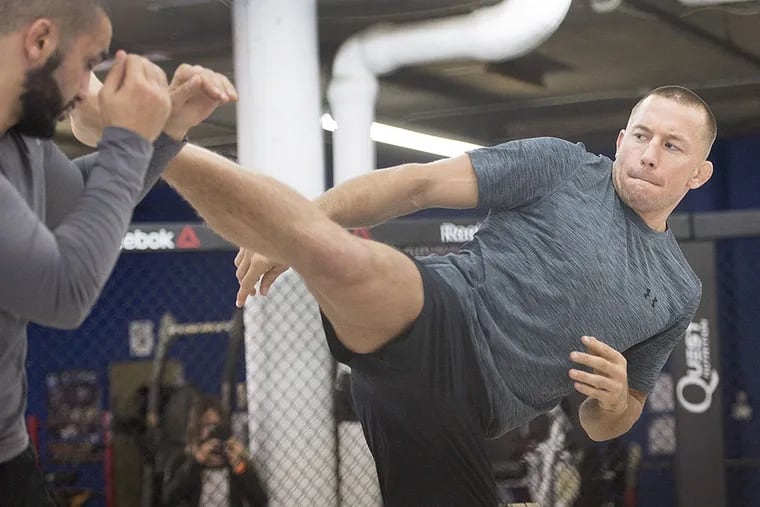 Georges St-Pierre, three-time former UFC welterweight champion, spars with his head trainer Firas Zahabi during a workout Wednesday, Oct. 25, 2017 in Montreal. St-Pierre will face Michael Bisping of a UFC middleweight title mixed martial arts bout in UFC 217 on Saturday, Nov. 4, 2017 in New York.