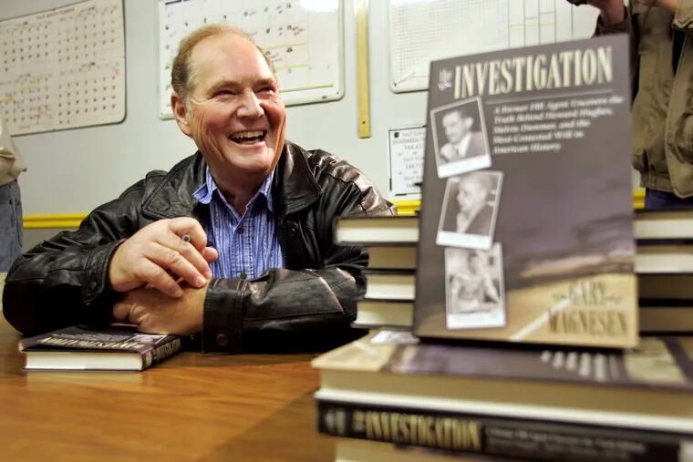 FILE - In this Nov. 10, 2005 file photo, Melvin Dummar smiles after signing copies of a book that Gary Magnesen had written about Dummar's claims that Howard Hughes left him a portion of the Hughes estate. Dummar, a delivery driver who falsely claimed that billionaire Howard Hughes left a handwritten will bequeathing him $156 million, has died in rural Nevada. Nye County Sheriff Sharon Wehrly said Dummar died Sunday, Dec. 9, 2018, under hospice care. He was 74. (Scott G. Winterton/Deseret Morning News via AP, File)