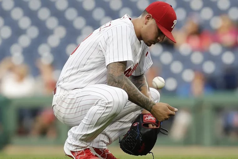 Phillies pitcher Vince Velasquez crouches after giving up a three-run home run in a loss to the Brewers on Friday. 