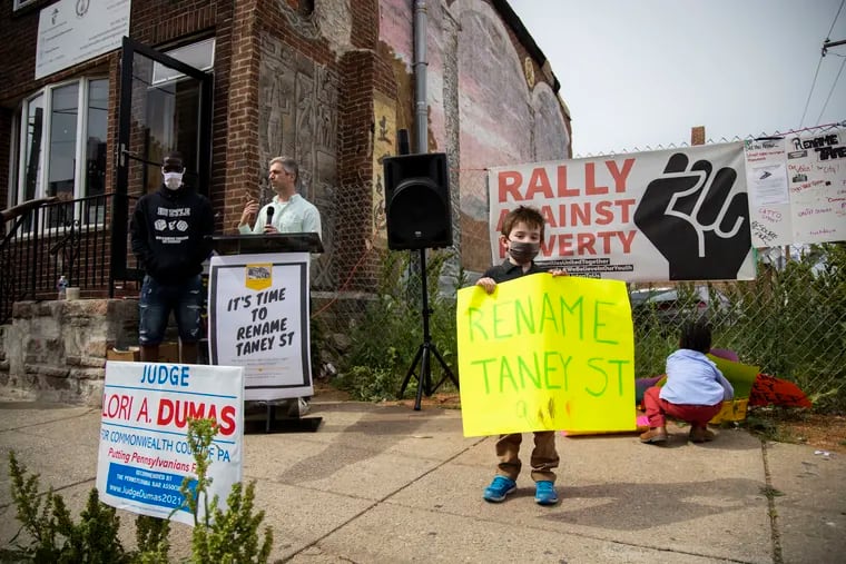 Asher Isserman, 4, holds a sign as Ben Keys speaks during a rally to rename Taney Street in Philadelphia on Sunday. Taney Street is believed  to be named for Roger Taney, former chief justice of the U.S. Supreme Court who authored the 1857 Dred Scott decision, writing in part that Black people “had no rights which the white man was bound to respect."