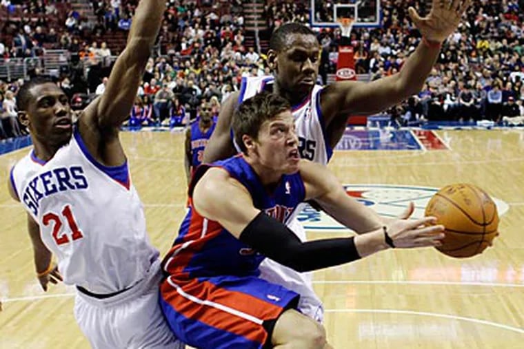 Thad Young and Lavoy Allen go for the block against the Pistons' Jonas Jerebko during the first half. (Matt Slocum/AP)