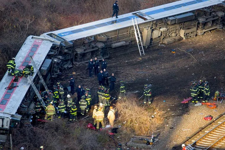 First responders tend to the scene of Sunday's deadly passenger-train derailment in the Bronx. (AP Photo)