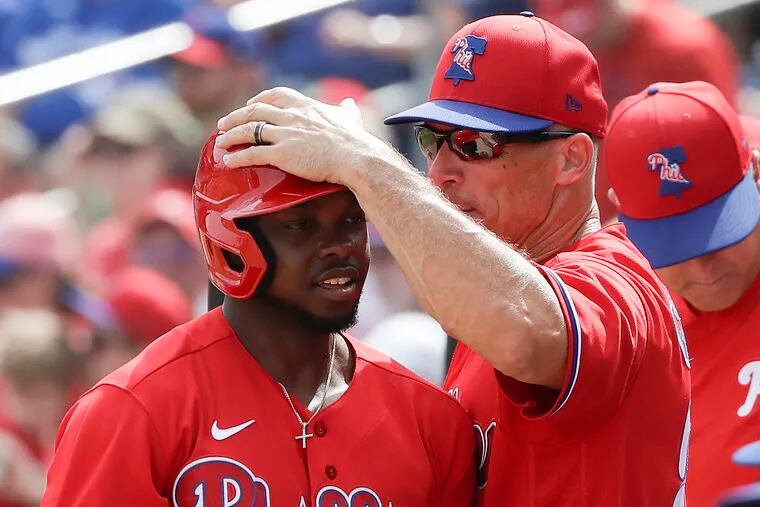 Phillies center fielder Roman Quinn gets a tap from manager Joe Girardi after hitting a home run in a spring-training game earlier this month.