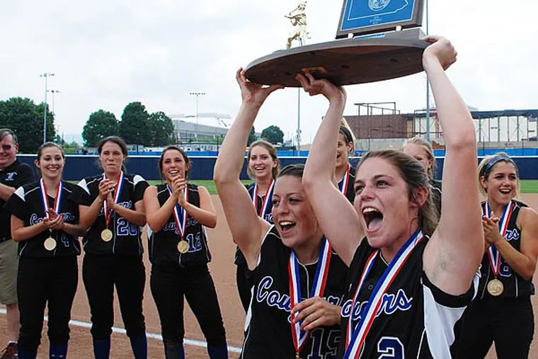 Springfield Delco's Lauren Scarpato (15), left, and Courtney Scarpato
(2) hold up the trophy after their 3-0 win over Bethlehem Catholic in
the PIAA Class AAA Softball Championship on June 13, 2014. Photo/Craig
Houtz