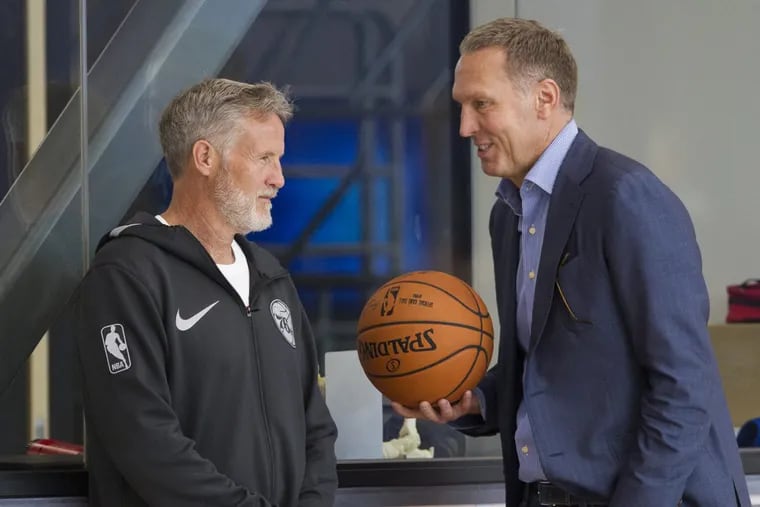 Sixers general manager Bryan Colangelo, right, and coach Brett Brown have reportedly agreed to an extra three years, keeping Brown here through the 2021-22 season.