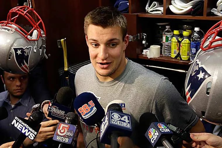 New England Patriots tight end Rob Gronkowski faces reporters in the
team's locker room at Gillette Stadium following NFL football practice
in Foxborough, Mass., Tuesday, Jan. 8, 2013. (Steven Senne/AP)