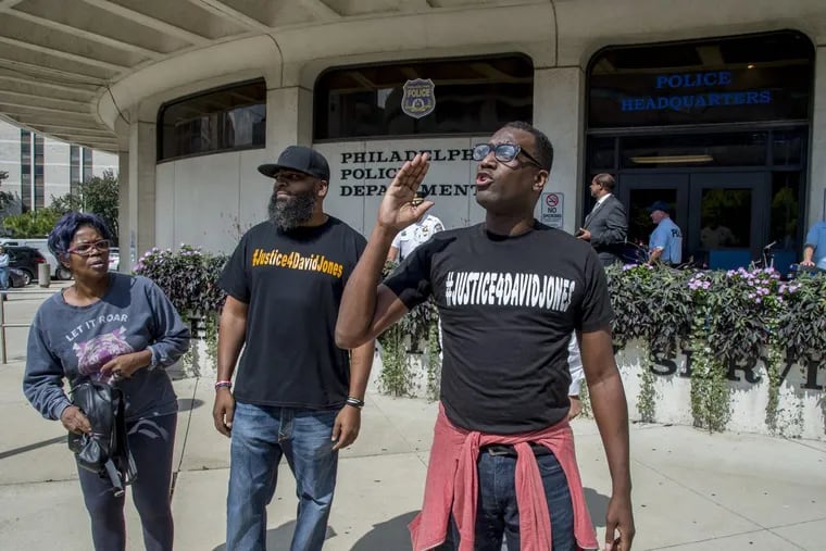 Protesters demonstrated outside police headquarters after  Commissioner Richard Ross announced the firing of a white officer who fatally shot a black man.