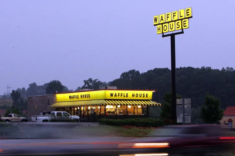 Traffic flashes by breakfast diners a a Waffle House near Dawsonville, Ga., Thursday, July 28, 2005.