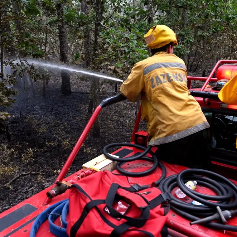 File: Firefighters monitoring hot areas after a June 2022 fire in Wharton State Forest. A fire that broke out April 24, 2024, reached 500 acres before it was fully contained.