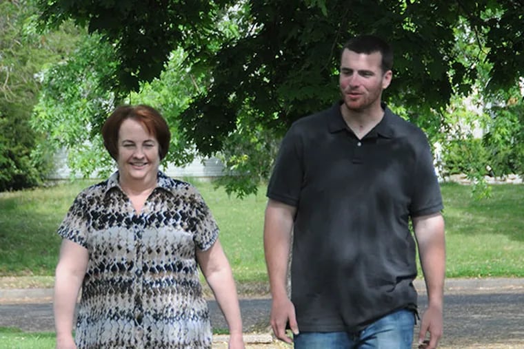 Barbara Gale walks with her son, Tyler Gale. Tyler suffered a severe brain injury in May of 2013. (Curt Hudson photo)