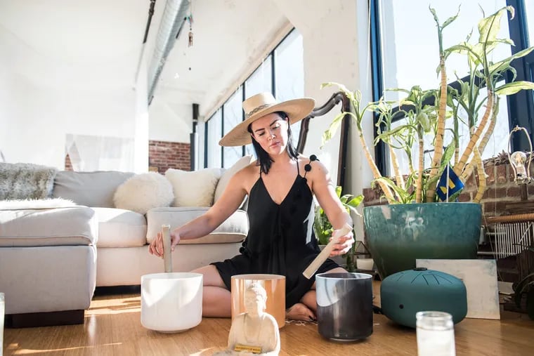 Luna Maye plays three quartz crystal bowls inside her Fishtown studio apartment, which she also occasionally opens to the public for community events under the name Haus of Intrigue.