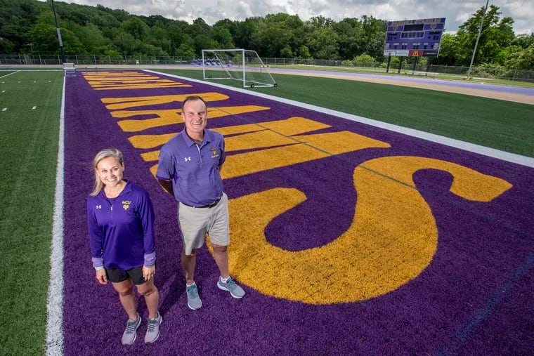Katie Morrison and John Smith, athletic trainers at West Chester University, on the field at Farrell Stadium.