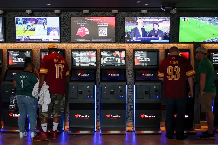 Betting machines line the wall at the Fanatics Sportsbook at FedEx Field in Landover, Md., on Sunday.