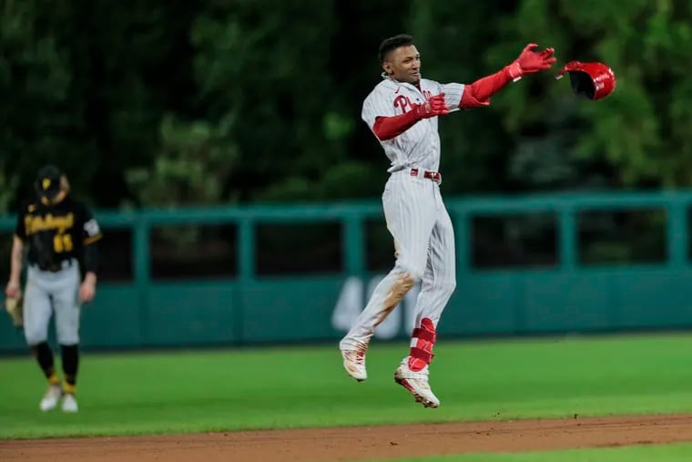 Phillies rookie Johan Rojas celebrates his walk-off hit against the Pirates in the 10th inning to clinch a wild-card berth on Tuesday.
