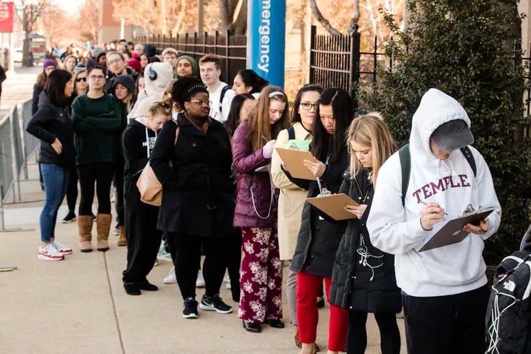 A line of mostly students wait to enter a vaccination clinic amid a mumps outbreak on the Temple University campus in Philadelphia, Wednesday, March 27, 2019. Health officials say the MMR vaccine, for measles, mumps and rubella, will be available to all Temple students, faculty and staff on Wednesday and Friday. (AP Photo/Matt Rourke)