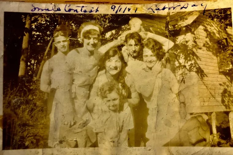 This family photo from 1927 is one of the few surviving images of Larry Saffron.  He stands in the center holding his son, Stanley Mark Saffron, on his shoulders. The smiling woman in the center is Larry's sister, Ruth. His wife, Dorothy, stands on his right. The other people in the photo could not be identified.