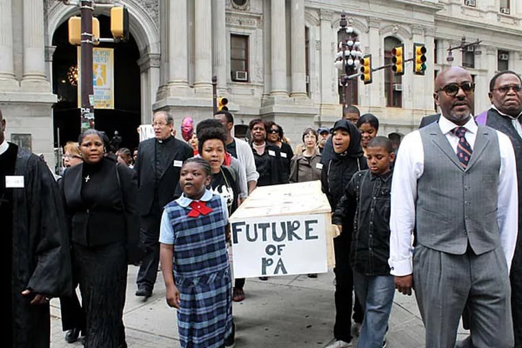 File photo: School children and members of POWER (Philadelphians Organized to Witness, Empower and Rebuild) stage a mock funeral for the future of Philadelphia public education. The procession, in May 2014, from City Hall to Gov. Corbett's city office, was sparked by the School District's announcement of a projected deficit and cuts. COURTNEY MARABELLA / Staff Photographer