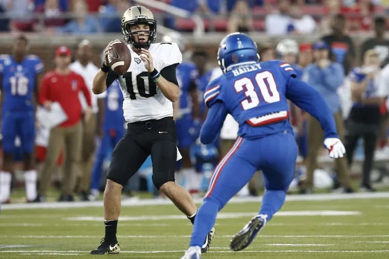 Central Florida quarterback McKenzie Milton (10) drops back to pass as SMU linebacker Shaine Hailey (30) defends during the first half of an NCAA college football game, Saturday, Nov. 4, 2017, in Dallas. (AP Photo/Mike Stone)