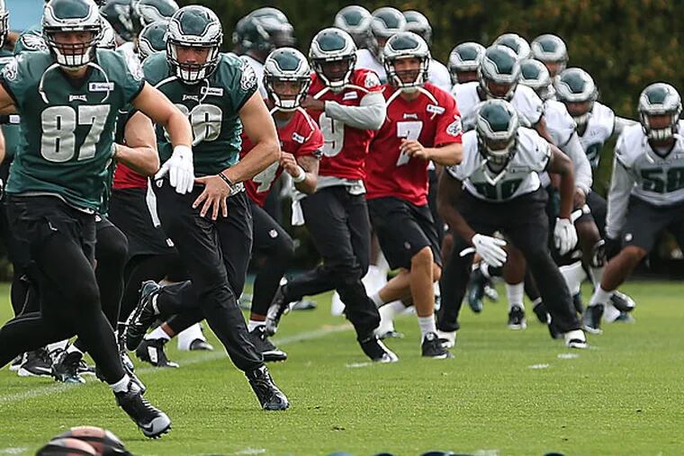 The players warm up during Eagles practice.